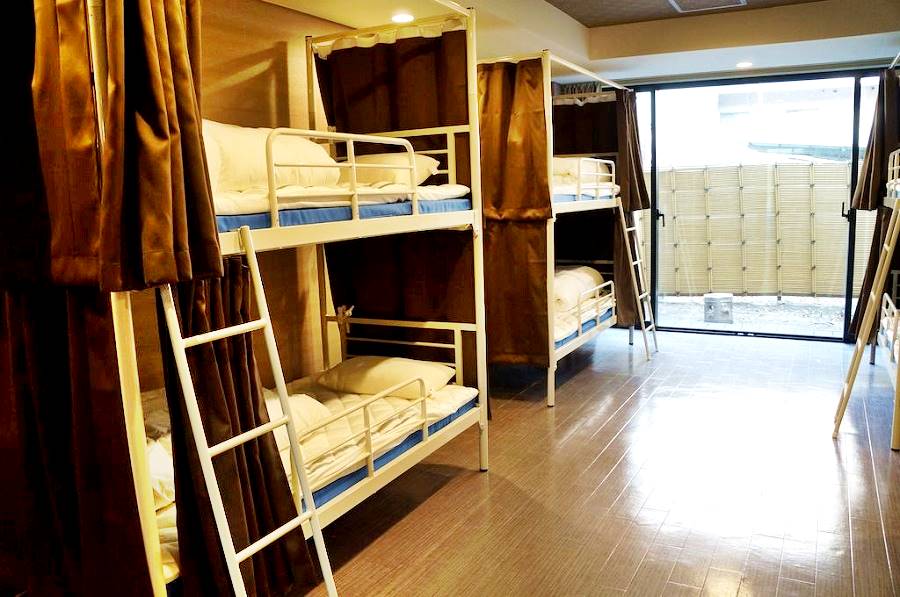 bunks with curtains in a Hostel Dorm Room