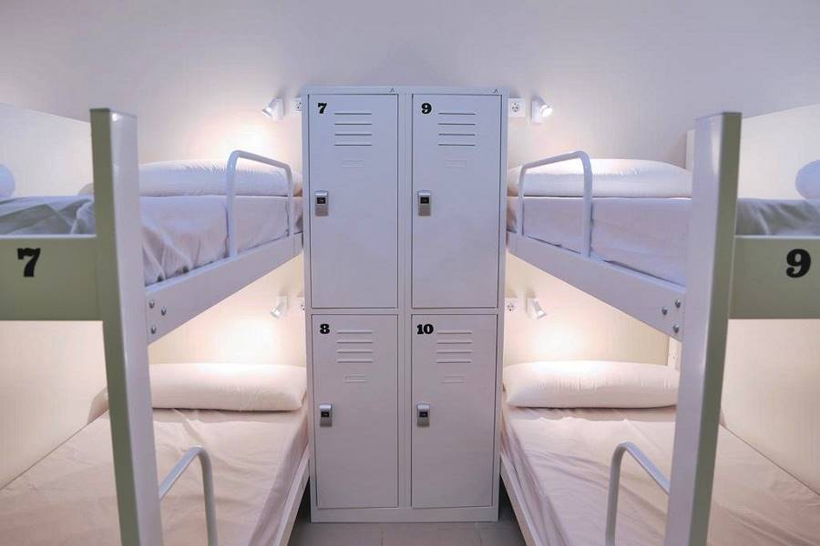 Hostel lockers and bunks in dorm room